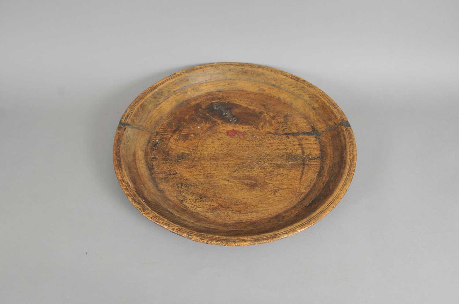 A large 18th century rustic farmhouse hewn shallow bowl / charger