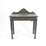 A late 19th / early 20th century carved oak side table