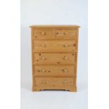 A pale pine chest of two short and four long drawer