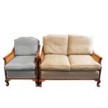 A two-piece modern bergère suite comprising two-seat sofa, 86 cm high, 124 cm wide x 85 cm deep,