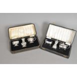 Two cased sets of silver cruets