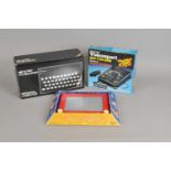 A boxed Sinclair ZX spectrum, an etch-a-sketch console and a Videosport console