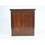 A George III country oak corner cupboard