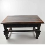 A heavy rustic oak dining table