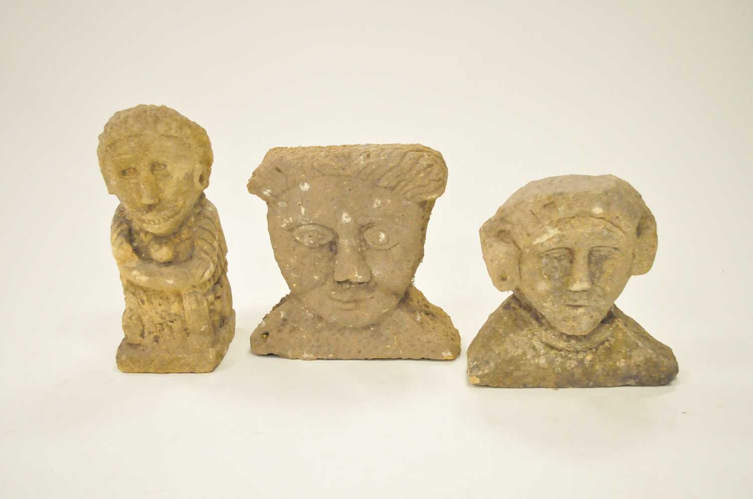 A stylised carved limestone figure and two stylised limestone busts