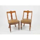 A set of eight late 19th / early 20th century oak framed dining chairs, in the style of the