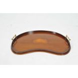 A small Edwardian kidney shaped mahogany drinks tray, with raised gallery, polished brass handles