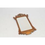 An Edwardian mahogany pier / wall mirror, the top with a pierced and carved seated gilded bird