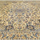 A large cream ground woven wool carpet, with central medallion and symmetrical stylised foliate