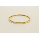 A 9ct gold diamond set bangle