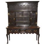 An early 18th century and later oak dresser base, the associated, later rack with a convex cornice