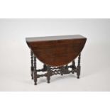A Restoration style oak gateleg table, the oval top on barley twist and block supports, 96cm wide