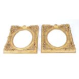 A pair of gilt framed wall mirrors, with scrolling pierced frames decorated with moulded foliate and