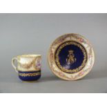 A Sèvres-style porcelain jewelled and monogrammed coffee cup and saucer