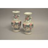 A pair of Chinese export polychrome vases, decorated with scenes of battle, 36cm high (A/F).