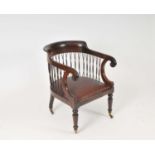 A 19th century rosewood library chair, the back with scrolled arms over woven spindles above a