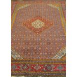 An eastern polychrome woven wool rug, decorated with a central kite shaped medallion, set within a
