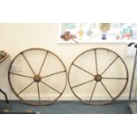 A pair of large cast iron cart wheels, 85 cm diameter.