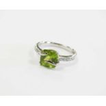 A 9ct white gold peridot and diamond ring