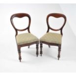 Eleven Victorian mahogany balloon-back dining chairs, with drop-in upholstered seats, raised on