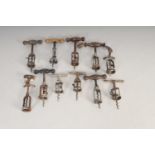 A mixed collection of eleven early 20th century corkscrews, some with turned wooden handles, (11).