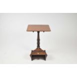 A small 19th century mahogany occastional tripod table with rounded tablet top over a turned stem