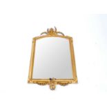 A 19th century gilt gesso framed wall mirror, the frame surmounted with a figural bust, enclosing an