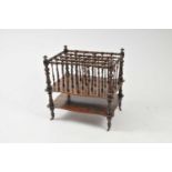 A Victorian mahogany Canterbury, with turned spindle gallery over two shaped platforms, turned