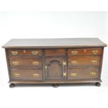 A George III mahogany mule chest, the rounded top over a central short drawer and arch panelled
