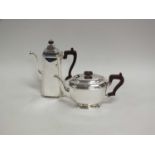 A silver coffee pot and teapot