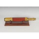 A Dolland of London three-drawer brass telescope, engraved 'Dolland, Day or Night', 100cm long, on a