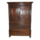 A 17th century and later 3-section livery cupboard with two fielded panel doors above a carved