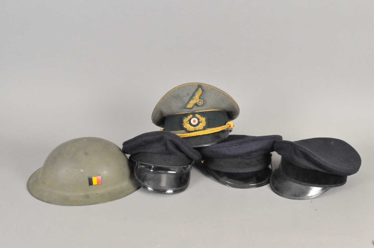 Collection of visor caps and a Belgian helmet