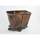 An unusual rustic sewn hide laundry cart, on a wooden frame and iron wheels, possibly elephant hide,