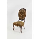 A Victorian rosewood framed parlour chair with intricate carved foliate and floral mounts raised