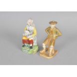 A Royal Worcester 'Scotsman' figure and a Staffordshire figure of Nell
