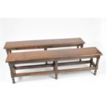 A pair of early 20th century oak hall benches in the 18th century style, with bevelled planed tops