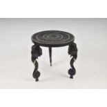 A late 19th / early 20th century Indian carved hardwood table, the circular top decorated