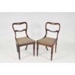 A set of six regency rosewood dining chairs, with carved rails, drop-in seats and carved tapering