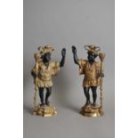 A pair of decorative cast candlesticks in the form of blackamoor figures