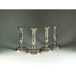 A set of four George III silver candlesticks