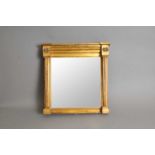A small 19th century gilded wall mirror, in the Regency style