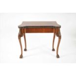 A 19th century folding mahogany card table in the George II style