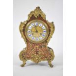 A late 19th century parquetry inlaid boulle mantel clock in the Louis XV style