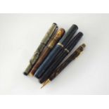 A collection of four fountain pens and a Conklin propelling pencil