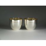 A pair of silver tumblers