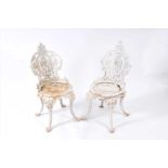 A pair of Victorian painted cast iron garden chairs