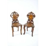 A pair of Black Forrest type 19th century continental hall chairs