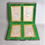 A cased set of Four Middle Eastern / Islamic silk panels