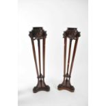 A pair of 19th century mahogany trefoil torcheres in the Adam style